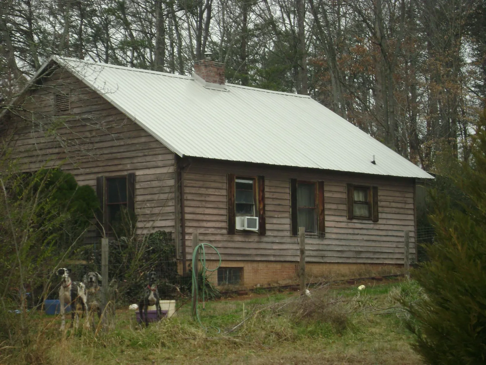 White metal roof on an old wood sided farmhouse, from a Metal Roof Installation job in West Eaton